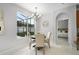 Cozy dining area with a view of the yard and a glimpse into the bedroom at 201 Hammock Dunes Pl, Orlando, FL 32828