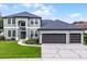Charming two-story home featuring a three-car garage and well-manicured lawn at 201 Hammock Dunes Pl, Orlando, FL 32828