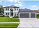Charming two-story home featuring a three-car garage and well-manicured lawn at 201 Hammock Dunes Pl, Orlando, FL 32828