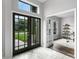 Bright foyer featuring a decorative front door and an adjacent home office at 201 Hammock Dunes Pl, Orlando, FL 32828