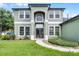 Inviting two-story home showcasing a walkway to a welcoming front door at 201 Hammock Dunes Pl, Orlando, FL 32828