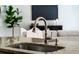 Close-up of the kitchen sink with granite countertop and a view of the living room at 201 Hammock Dunes Pl, Orlando, FL 32828