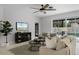 Bright, open living room with stylish decor, views of the pool, and a modern ceiling fan at 201 Hammock Dunes Pl, Orlando, FL 32828