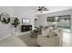 Open-concept living room with views of the pool, a modern ceiling fan, and stylish decor at 201 Hammock Dunes Pl, Orlando, FL 32828