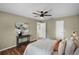 This main bedroom is adorned with an elegant table, abstract art, and a stylish ceiling fan at 201 Hammock Dunes Pl, Orlando, FL 32828