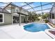 The screened-in pool sits in the backyard with a dining area and patio attached to the house at 201 Hammock Dunes Pl, Orlando, FL 32828