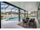 A screened-in pool area features a table and chairs under a covered patio for outdoor entertaining at 201 Hammock Dunes Pl, Orlando, FL 32828