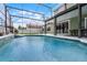 This inviting screened-in pool has beautiful water and is conveniently located next to the house at 201 Hammock Dunes Pl, Orlando, FL 32828