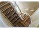 Hardwood staircase features white railings, a bright window, and leads to the upper level of the home at 201 Hammock Dunes Pl, Orlando, FL 32828