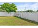 Well-maintained, expansive backyard featuring a privacy fence and lush green grass at 2017 W Gore St, Orlando, FL 32805