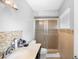 Bathroom features glass shower doors, tiled shower, and vanity with a marble countertop at 2017 W Gore St, Orlando, FL 32805