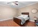 Bedroom features hardwood floors, ceiling fan, natural light and neutral color palette at 2017 W Gore St, Orlando, FL 32805