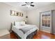 Bedroom with hardwood floors, soft light, ceiling fan, and charmingly decorated space at 2017 W Gore St, Orlando, FL 32805