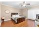Bedroom features hardwood floors, ceiling fan, natural light and a warm, neutral color palette at 2017 W Gore St, Orlando, FL 32805