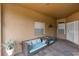 Covered patio with tiled floors and cozy outdoor seating area with cushioned sofas at 2017 W Gore St, Orlando, FL 32805