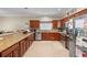 A kitchen featuring wood cabinets, granite countertops, stainless steel appliances, and a breakfast bar at 2017 W Gore St, Orlando, FL 32805