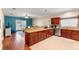 Open kitchen with granite countertops, stainless steel appliances, breakfast bar, and adjacent living space at 2017 W Gore St, Orlando, FL 32805