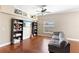Open living area with hardwood floors, neutral color palette, ceiling fan and built-in bookcases at 2017 W Gore St, Orlando, FL 32805