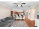 Living room with hardwood floors, a gray sofa, bar seating, and an open view into the kitchen at 2017 W Gore St, Orlando, FL 32805