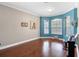 Living area showcases hardwood floors, built-in bay window, and accent wall with light fixture at 2017 W Gore St, Orlando, FL 32805