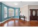 Living area showcases hardwood floors, bay window, accent wall, grand front door and stylish decor at 2017 W Gore St, Orlando, FL 32805