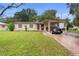 A cozy, single-story home boasts a convenient carport, neat front lawn, and inviting entrance at 2044 W Gore St, Orlando, FL 32805