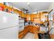 A full kitchen featuring wooden cabinets and tile flooring, offering a functional space at 2044 W Gore St, Orlando, FL 32805