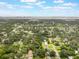 Panoramic aerial view of a neighborhood with numerous trees and glimpses of a distant cityscape at 2050 Anne Cir, South Daytona, FL 32119