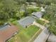Aerial view of the home in a neighborhood setting with mature trees at 2050 Anne Cir, South Daytona, FL 32119