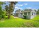 This backyard features a brick patio, lush lawn, and ample room for recreation at 2050 Anne Cir, South Daytona, FL 32119