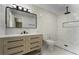 This renovated bathroom boasts modern tiling, vanity, and updated shower with rainfall head at 2050 Anne Cir, South Daytona, FL 32119