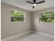 This light and airy bedroom boasts new marble floors and two large windows at 2050 Anne Cir, South Daytona, FL 32119