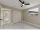 This bright, airy bedroom features new floors, a modern ceiling fan, and large closet at 2050 Anne Cir, South Daytona, FL 32119