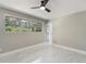 Bright bedroom with a modern ceiling fan, neutral walls, and a large window at 2050 Anne Cir, South Daytona, FL 32119