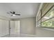 Bright bedroom features marble floors, large window, ceiling fan, and closet at 2050 Anne Cir, South Daytona, FL 32119