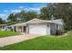 View of the home showcasing the attached garage and a lush green lawn at 2050 Anne Cir, South Daytona, FL 32119