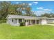 Charming single-story home featuring a covered front porch and a well-maintained lawn at 2050 Anne Cir, South Daytona, FL 32119