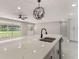 Open kitchen with an island featuring a quartz countertop, modern sink, and stylish light fixture at 2050 Anne Cir, South Daytona, FL 32119