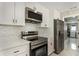 Kitchen featuring stainless steel appliances, white cabinets, quartz countertops, and modern design at 2050 Anne Cir, South Daytona, FL 32119