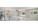 Bright open-concept living space featuring modern lighting, sleek floors, and French doors leading to the porch at 2050 Anne Cir, South Daytona, FL 32119