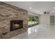 Bright living room featuring a brick fireplace, sliding glass doors, and elegant marble floors at 2050 Anne Cir, South Daytona, FL 32119