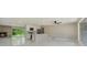 Modern open-concept living area with a peninsula kitchen, contemporary lighting, and glossy tile floors at 2050 Anne Cir, South Daytona, FL 32119