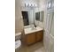 Bathroom features a single vanity with a mirror and a standard toilet at 223 Palermo St, Davenport, FL 33897