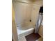 Bright bathroom features a tub with shower and neutral tile surround at 223 Palermo St, Davenport, FL 33897