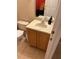 Small bathroom with a vanity and a toilet, tile flooring and warm toned walls at 223 Palermo St, Davenport, FL 33897