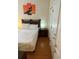 Bright bedroom with wood floors features a twin bed, nightstand, and closet at 223 Palermo St, Davenport, FL 33897