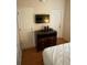 Bedroom with a standard bed, dresser, and a television mounted on the wall at 223 Palermo St, Davenport, FL 33897