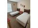 Bright bedroom featuring two twin beds and neutral wall decor at 223 Palermo St, Davenport, FL 33897