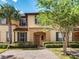 Charming two-story townhome featuring lush landscaping and a welcoming entryway at 223 Palermo St, Davenport, FL 33897