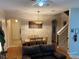 Inviting living room features a dining area, wooden floors, a ceiling fan, and a staircase to the second floor at 223 Palermo St, Davenport, FL 33897